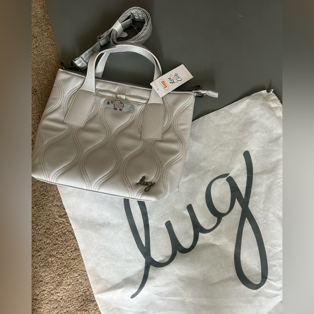Brand new lug cross body purse silver